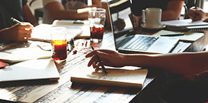 Close up of table with notebooks and a laptop